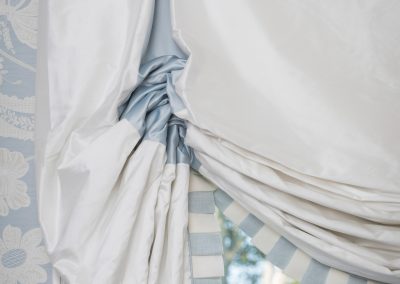 Newton homes, window treatment details, fabric inserts, fabric pleat inserts, white roman shades, blue and white stripe pleats, pleated ruffle, light blue and white floral wallpaper, white moldings