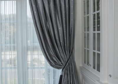 curtains and drapes, curtains, Newton home, window treatment detail, crystal tiebacks, white sheer drapes, sheers, traversing drapes, drapes that puddle on floor, white china cabinets, built in cabintry, white cabinets with glass fronts, crystal cabinet knobs