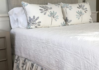upholstered headboard, bedskirt, bedding, white bedspread, bedroom design, pillow shams, bedskirt, upholstery